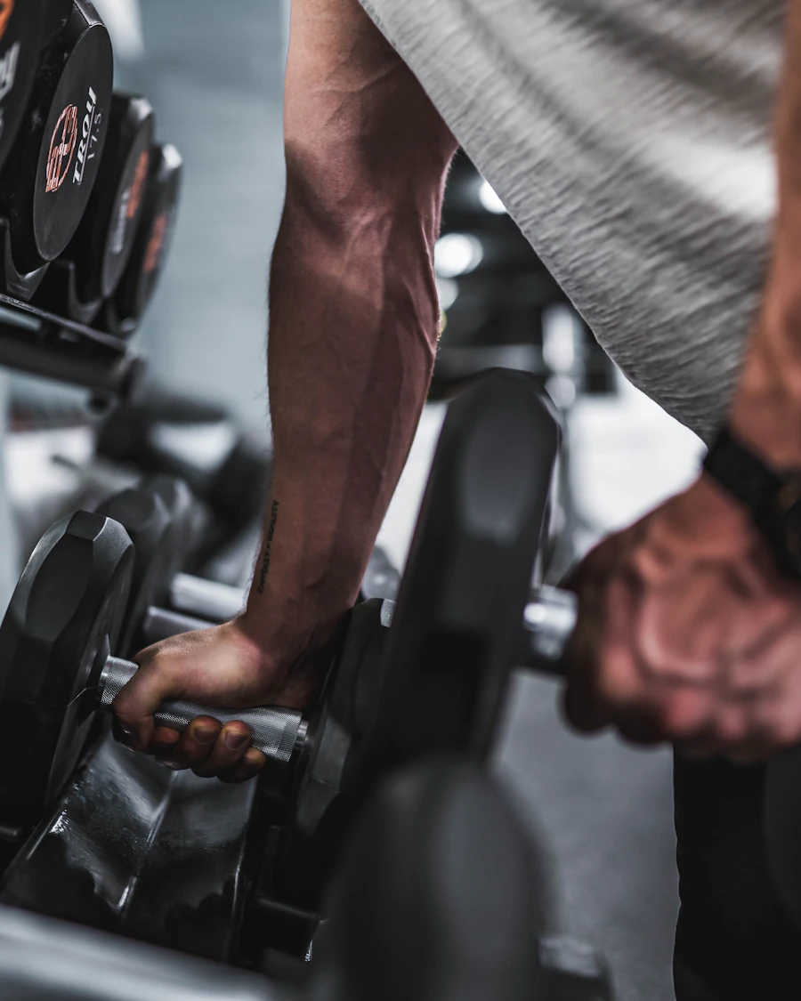 Member training with dumbbells at FitCore fitness floor