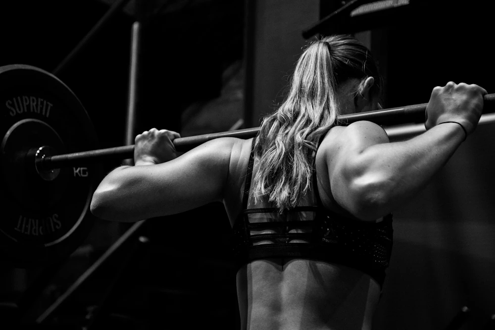 Athlete focusing on mobility and recovery work in a bright training space
